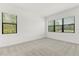 A carpeted bedroom featuring bright windows bringing in plenty of natural light at 1242 Butterfly Orchid Rd, Davenport, FL 33837