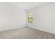 Bright bedroom features neutral carpet, white walls, and natural light from the large window at 1242 Butterfly Orchid Rd, Davenport, FL 33837