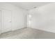A bedroom with plush carpeting and a doorway, and a walk in closet with an open door at 1242 Butterfly Orchid Rd, Davenport, FL 33837