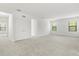 Large bedroom featuring plush carpeting, natural light, and double door closet at 1242 Butterfly Orchid Rd, Davenport, FL 33837