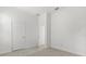 Bedroom with neutral carpet, white walls, and two doors to other rooms at 1242 Butterfly Orchid Rd, Davenport, FL 33837