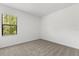 Cozy bedroom with plush carpeting and a large window overlooking greenery at 1242 Butterfly Orchid Rd, Davenport, FL 33837
