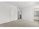 A bedroom with plush carpeting and a doorway leading to the ensuite bath at 1242 Butterfly Orchid Rd, Davenport, FL 33837