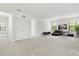 Bright and spacious living room featuring plush carpeting and modern decor at 1242 Butterfly Orchid Rd, Davenport, FL 33837