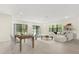 Open-concept living and dining area with access to backyard views at 1242 Butterfly Orchid Rd, Davenport, FL 33837