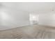 Open loft area with plush carpeting, ideal for a recreation room or home office at 1242 Butterfly Orchid Rd, Davenport, FL 33837