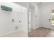 A bright mud room area with tile floors and laundry hookups near a door at 1242 Butterfly Orchid Rd, Davenport, FL 33837