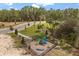 Community playground features a swing set, slide, and other fun equipment for children, all fenced for added security at 1242 Butterfly Orchid Rd, Davenport, FL 33837