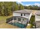 Aerial view of a private screened-in pool and spa offers relaxation and backyard enjoyment at 1242 Butterfly Orchid Rd, Davenport, FL 33837