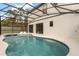 Relaxing screened-in pool area features a hot tub, patio and easy access to the home at 1242 Butterfly Orchid Rd, Davenport, FL 33837