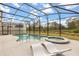 Inviting screened-in pool with spa and comfortable lounge chairs for relaxing and enjoying the view at 1242 Butterfly Orchid Rd, Davenport, FL 33837