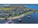 An aerial view captures a waterfront community featuring homes with private docks and serene lake access at 16629 Broadwater Ave, Winter Garden, FL 34787