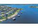 A picturesque aerial view showcases a lakeside community with homes boasting private docks, perfect for waterfront living at 16629 Broadwater Ave, Winter Garden, FL 34787