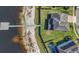 An aerial view of a beautiful home on a lake with a private dock and a backyard firepit, great for outdoor living at 16629 Broadwater Ave, Winter Garden, FL 34787
