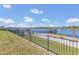Stunning backyard view showcasing a well-maintained lawn, lake access, and the surrounding neighborhood at 16629 Broadwater Ave, Winter Garden, FL 34787