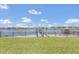 Picturesque backyard with a view of a serene lake, neighborhood homes, and private docks at 16629 Broadwater Ave, Winter Garden, FL 34787