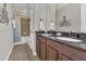 This is a bathroom with a granite countertop, tile flooring, and an octopus decoration at 16629 Broadwater Ave, Winter Garden, FL 34787