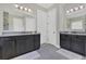 Elegant bathroom featuring dual vanities with dark cabinets, grey tile flooring, and ample space at 16629 Broadwater Ave, Winter Garden, FL 34787