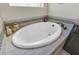 Close-up of a modern soaking tub with stylish tile surround and elegant fixtures at 16629 Broadwater Ave, Winter Garden, FL 34787