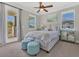 Bedroom with a ceiling fan, a balcony, and lots of natural light from the windows at 16629 Broadwater Ave, Winter Garden, FL 34787