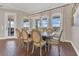 A well-lit dining room featuring a hardwood floor, a modern light fixture, and scenic outdoor views at 16629 Broadwater Ave, Winter Garden, FL 34787