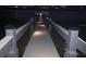 A long and lighted boat dock extends into the lake, offering a peaceful retreat under the night sky at 16629 Broadwater Ave, Winter Garden, FL 34787
