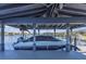 Covered boat dock features a boat lift and covered boat with navy canvas at 16629 Broadwater Ave, Winter Garden, FL 34787