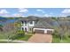 Stunning two-story home with a tile roof, two-car garage, well-manicured lawn, and partial lake view at 16629 Broadwater Ave, Winter Garden, FL 34787