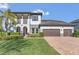 Beautiful two-story home with a brick-paved driveway, a two-car garage, and a meticulously maintained lawn at 16629 Broadwater Ave, Winter Garden, FL 34787