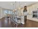 A gourmet kitchen featuring a spacious island with seating, hardwood floors, and modern stainless steel appliances at 16629 Broadwater Ave, Winter Garden, FL 34787