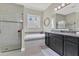 The main bathroom has a glass shower, soaking tub with tile surround, and granite countertop at 16629 Broadwater Ave, Winter Garden, FL 34787