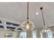 A contemporary designed space featuring decorative pendant lights, coffered ceilings, and large windows at 16629 Broadwater Ave, Winter Garden, FL 34787