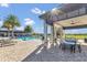 Community pool with lounge seating and covered patio area perfect for relaxing and entertaining on a sunny day at 16629 Broadwater Ave, Winter Garden, FL 34787
