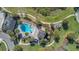Aerial view of a community pool area with lounge chairs, playground, and lush landscaping at 16629 Broadwater Ave, Winter Garden, FL 34787