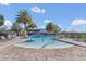 Resort-style pool featuring a splash pad area, surrounded by palm trees and plenty of lounge chairs for sunbathing at 16629 Broadwater Ave, Winter Garden, FL 34787