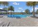 A large swimming pool features a zero entry access, a splashpad, and an abundance of lounge chairs at 16629 Broadwater Ave, Winter Garden, FL 34787