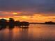 Beautiful sunset over the water, featuring fiery orange skies reflected on the calm surface at 16629 Broadwater Ave, Winter Garden, FL 34787
