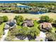 Aerial view of three homes situated near a scenic lake and golf course community at 1720 Bridgets Ct, Kissimmee, FL 34744