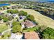 Aerial view of a home featuring a screened pool and golf course at 1720 Bridgets Ct, Kissimmee, FL 34744