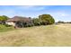 A serene backyard backing onto a lush golf course, providing a private outdoor oasis at 1720 Bridgets Ct, Kissimmee, FL 34744