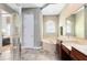 Elegant bathroom showcasing a soaking tub, dual vanities, and tiled floor with a glass shower at 1720 Bridgets Ct, Kissimmee, FL 34744