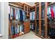Spacious walk-in closet with custom wood shelving and glass-front cabinets for optimal organization at 1720 Bridgets Ct, Kissimmee, FL 34744