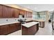 Spacious kitchen featuring wooden cabinets, stainless appliances, a kitchen island and tile floors at 1720 Bridgets Ct, Kissimmee, FL 34744