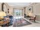 Cozy living room with a decorative rug, couch, and French doors that lead to the backyard at 1720 Bridgets Ct, Kissimmee, FL 34744