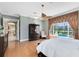 Bright bedroom with a ceiling fan, view of the pool, and doorway to an adjacent hallway at 1720 Bridgets Ct, Kissimmee, FL 34744