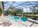 Enclosed pool area surrounded by a manicured golf course with seating to enjoy the view at 1720 Bridgets Ct, Kissimmee, FL 34744