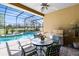 Enclosed lanai with seating, bbq grill and pool with a fountain that overlooks the golf course at 1720 Bridgets Ct, Kissimmee, FL 34744