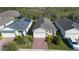 Aerial view of the property showcasing a well-maintained home with brick driveway and green landscaping at 17398 Blazing Star Cir, Clermont, FL 34714