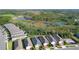 An aerial view of a residential area adjacent to a natural conservation area with ponds and lush greenery at 17398 Blazing Star Cir, Clermont, FL 34714