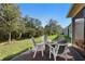 Outdoor seating area featuring a fire pit and Adirondack chairs with a peaceful backyard at 17398 Blazing Star Cir, Clermont, FL 34714